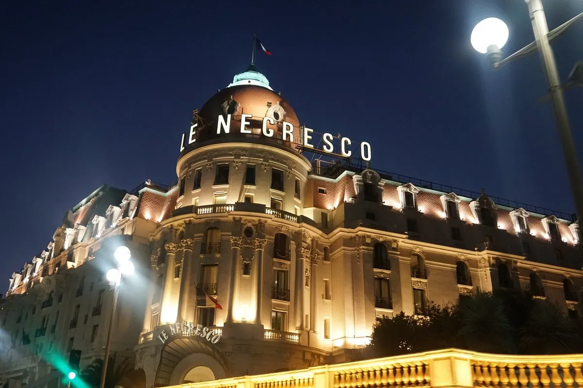 The Negresco with its pink dome and illuminated sign one evening on the Promenade des Anglais in Nice