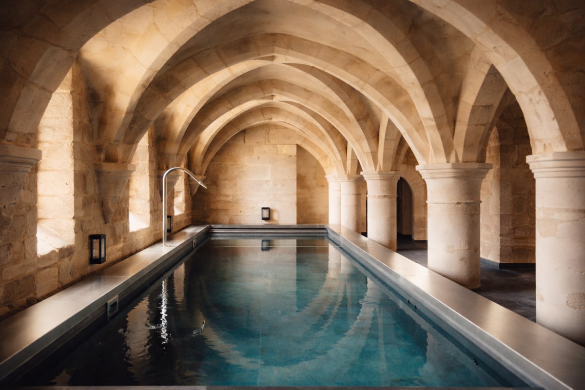 Vaulted stone indoor pool with arched ceiling at the hotel spa