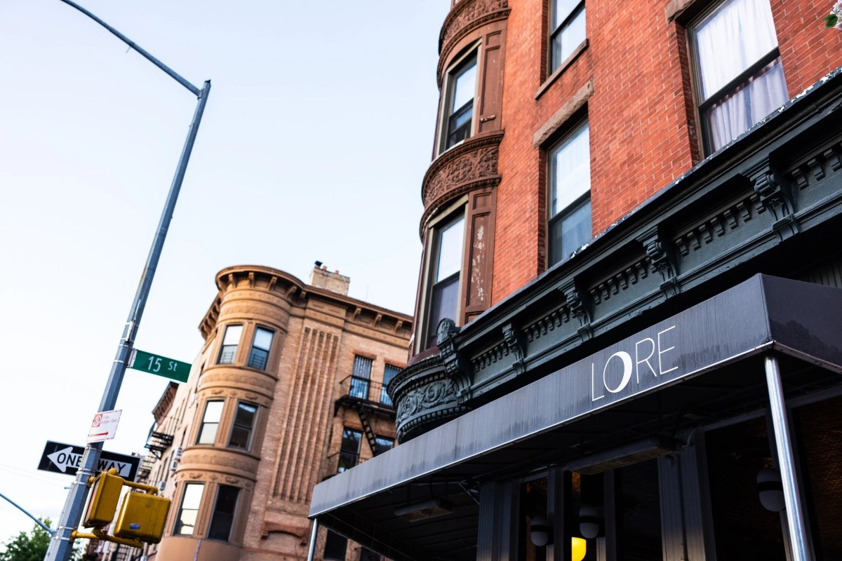 Exterior view of LORE restaurant storefront with awning and sign, Brooklyn brownstone street corner