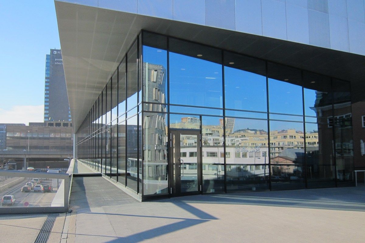 Exterior glass facade of Maaemo restaurant with Oslo skyline reflected in the windows