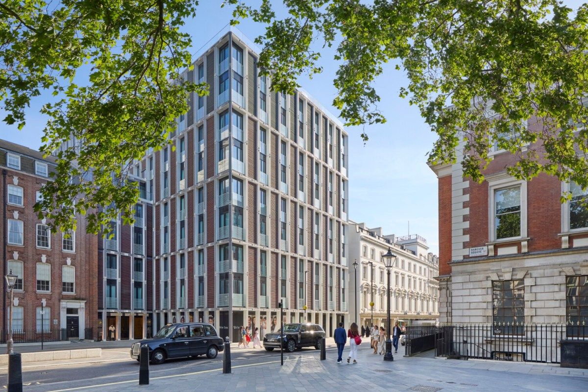 Exterior facade of Mandarin Oriental Mayfair building on a London street, surrounded by trees and nearby buildings