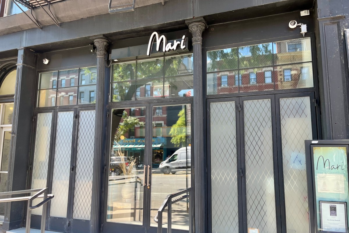 Exterior storefront of Mari restaurant in NYC, black facade with illuminated 'Mari' sign and glass doors