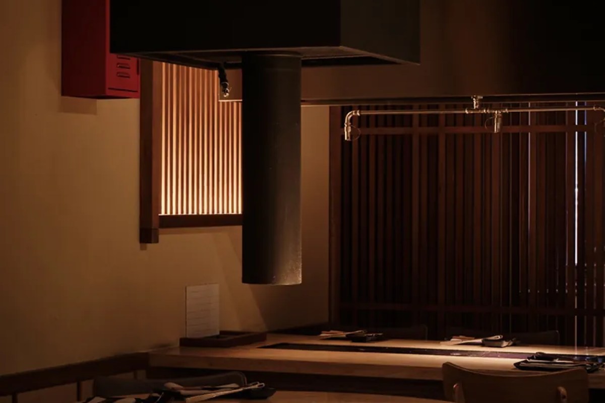 Interior view of dining counter with wooden slat screen and hanging exhaust hood