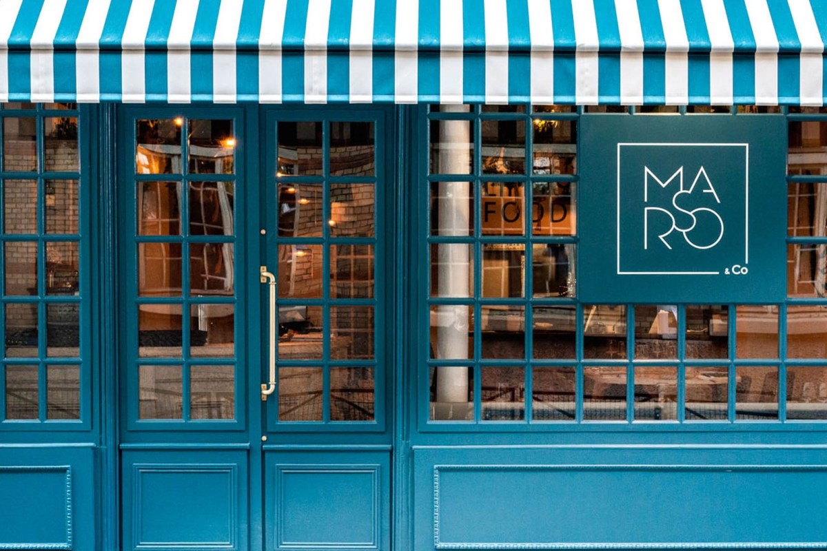 Exterior facade of Marso & Co with teal striped awning, teal doors and windows, and the restaurant's sign.