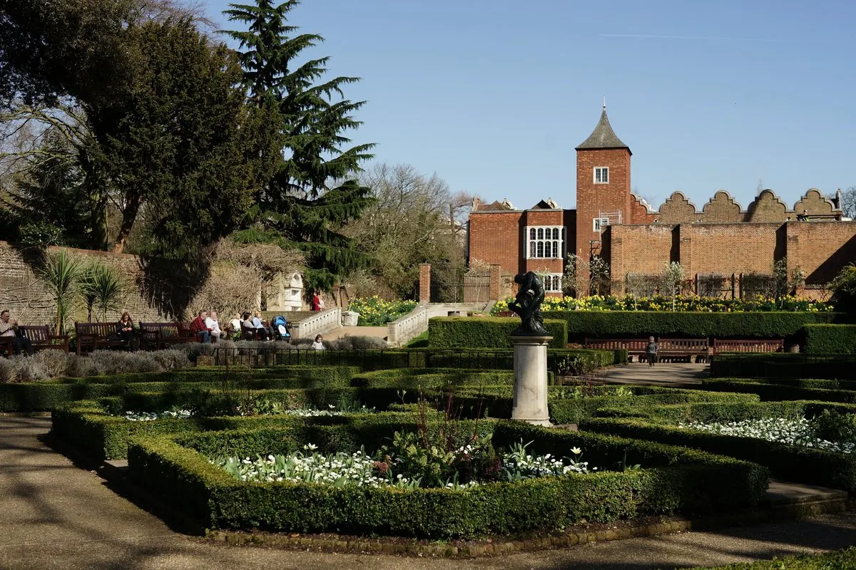 The formal gardens in Holland Park, London, with the ruins of Holland House behind