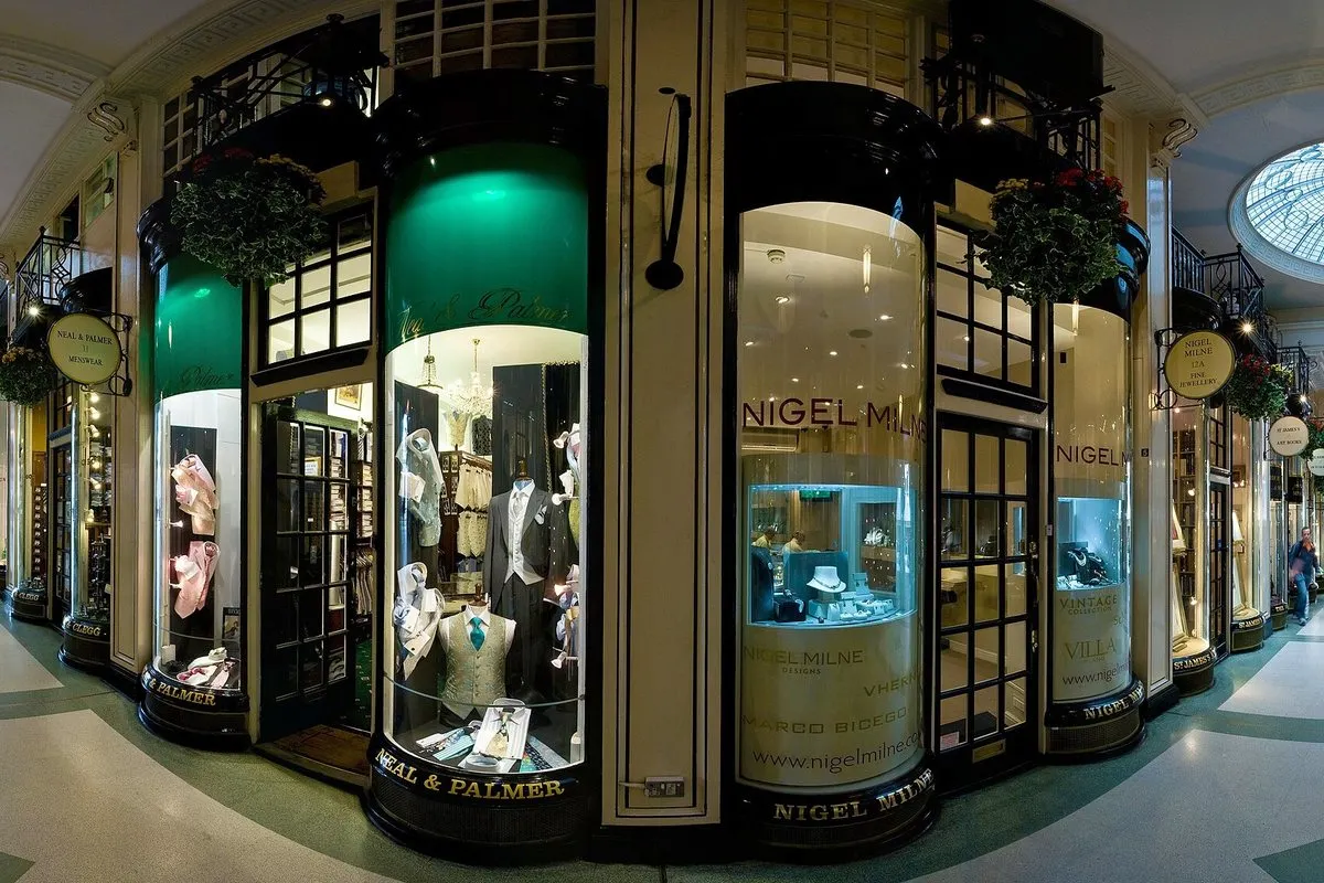 Inside Piccadilly Arcade in London, with bow-fronted shop windows under a glass roof