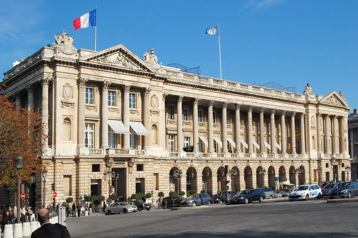 Hôtel de Crillon with colonnade and flags facing Place de la Concorde in Paris