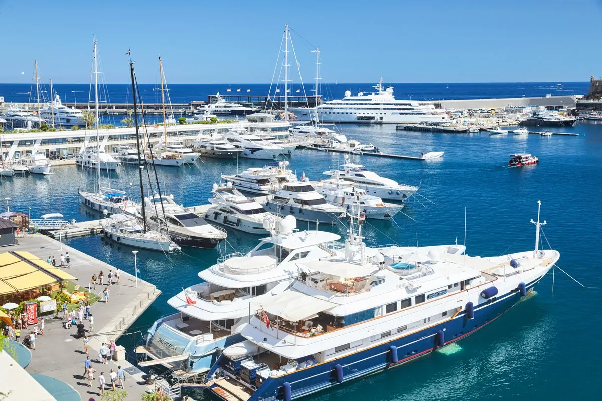 Superyachts and sailing boats moored in Port Hercule in Monaco ahead of the Monaco Yacht Show, with the quay and the sea behind
