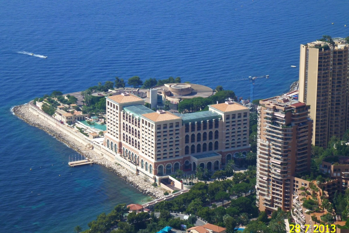 Aerial view of the entire Monte Carlo Bay Hotel & Resort peninsula surrounded by the sea