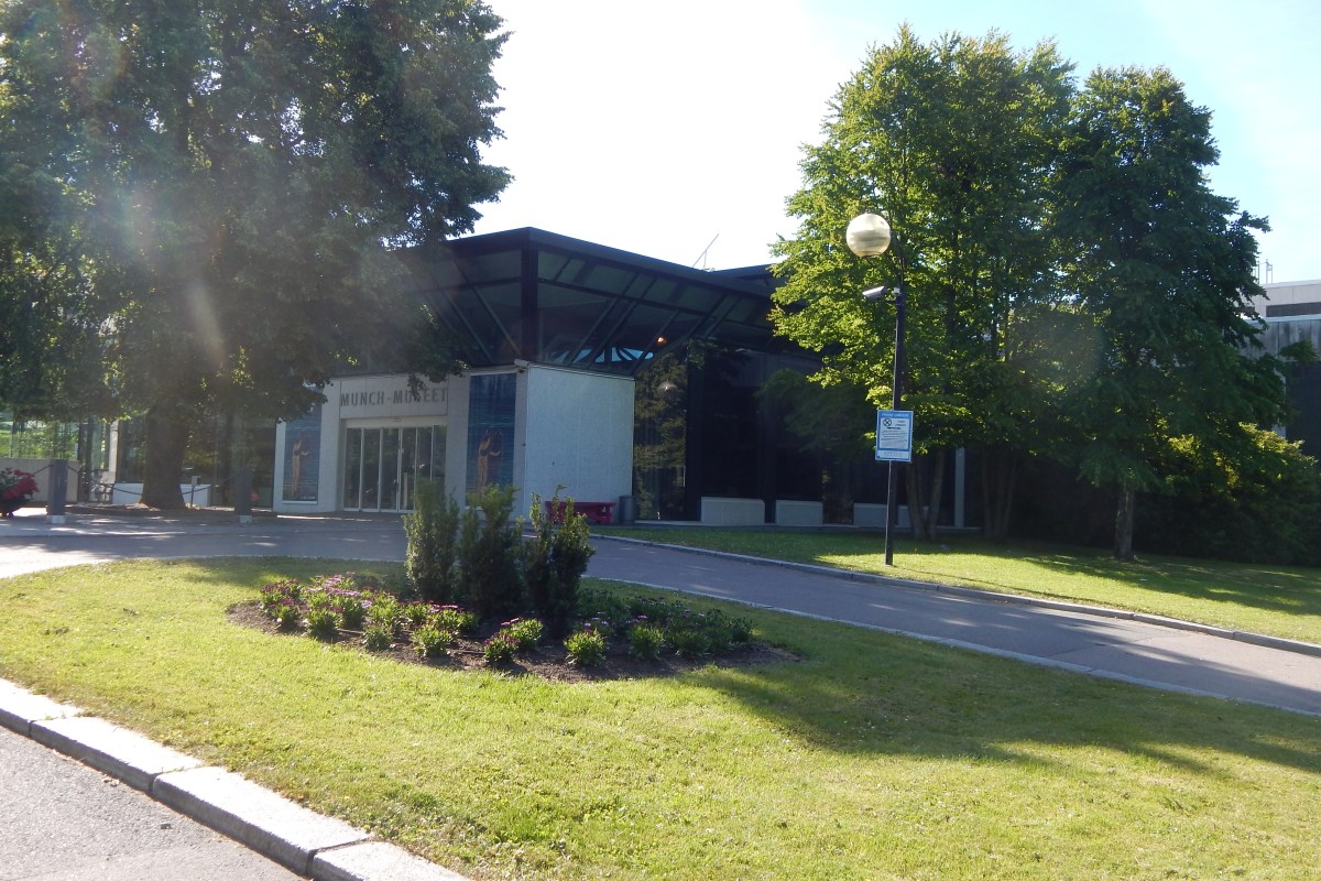 Old Munch Museum exterior seen through trees on a sunny day