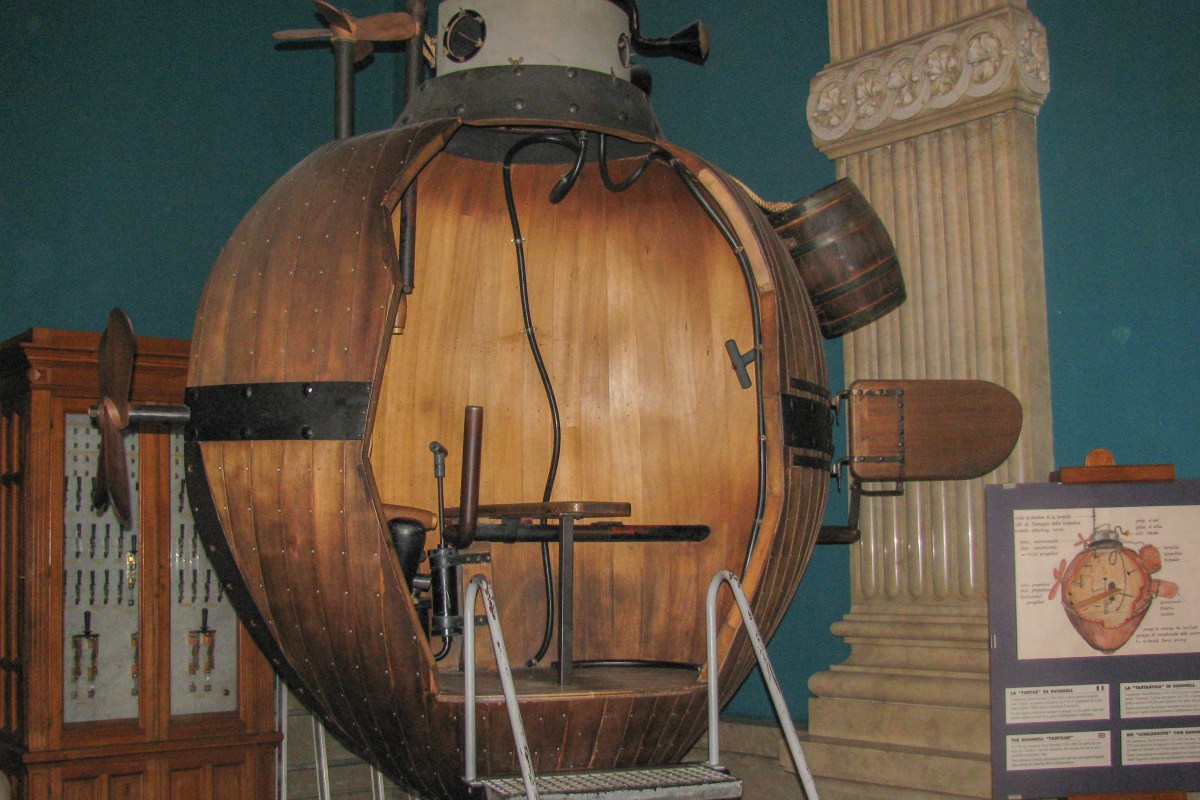 Antique wooden submersible 'Bushnell Turtle' replica displayed inside the museum's historic hall.