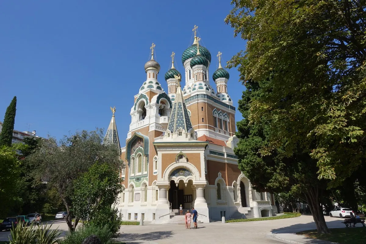 The Russian Orthodox Cathedral of Saint-Nicolas in Nice, with its green onion domes and brick and white façade among trees