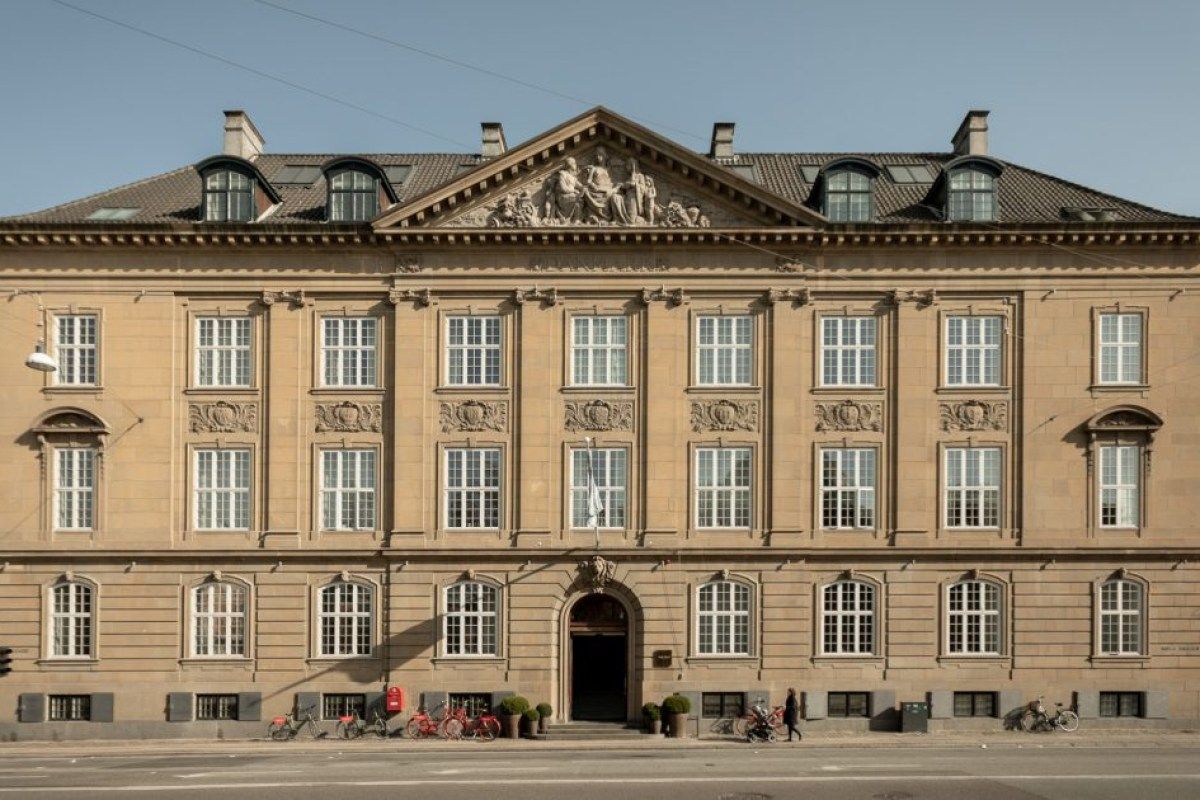 Facade of Nobis Hotel Copenhagen, classical sandstone building with ornate pediment