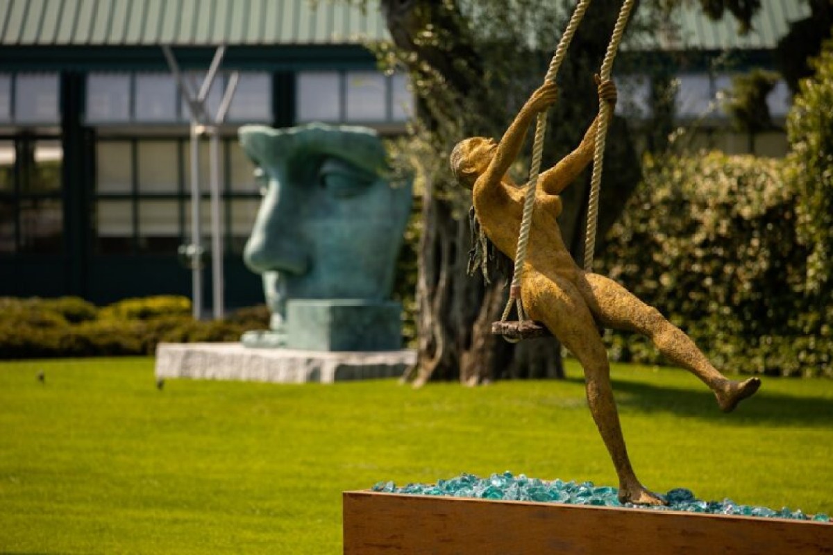 Garden with sculptures and view of restaurant exterior building in background