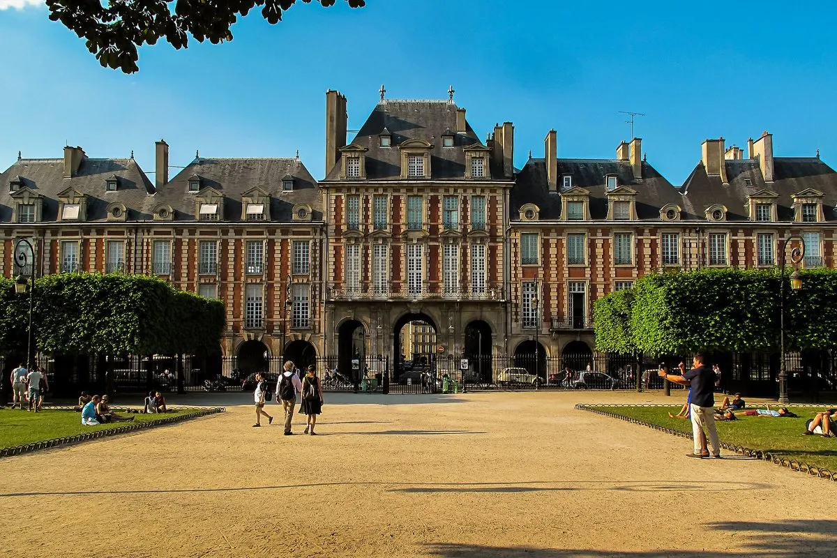 The Pavillon de la Reine rising above the brick arcades on the north side of place des Vosges