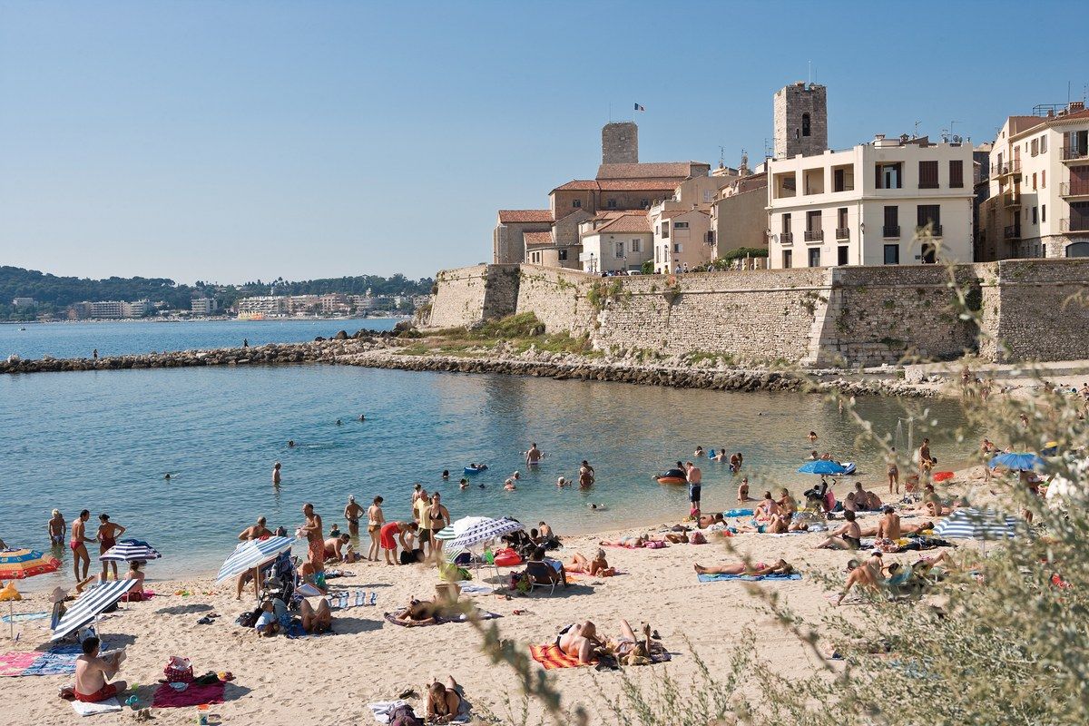 The sandy Plage de la Gravette below the ramparts of Old Antibes, by the harbour