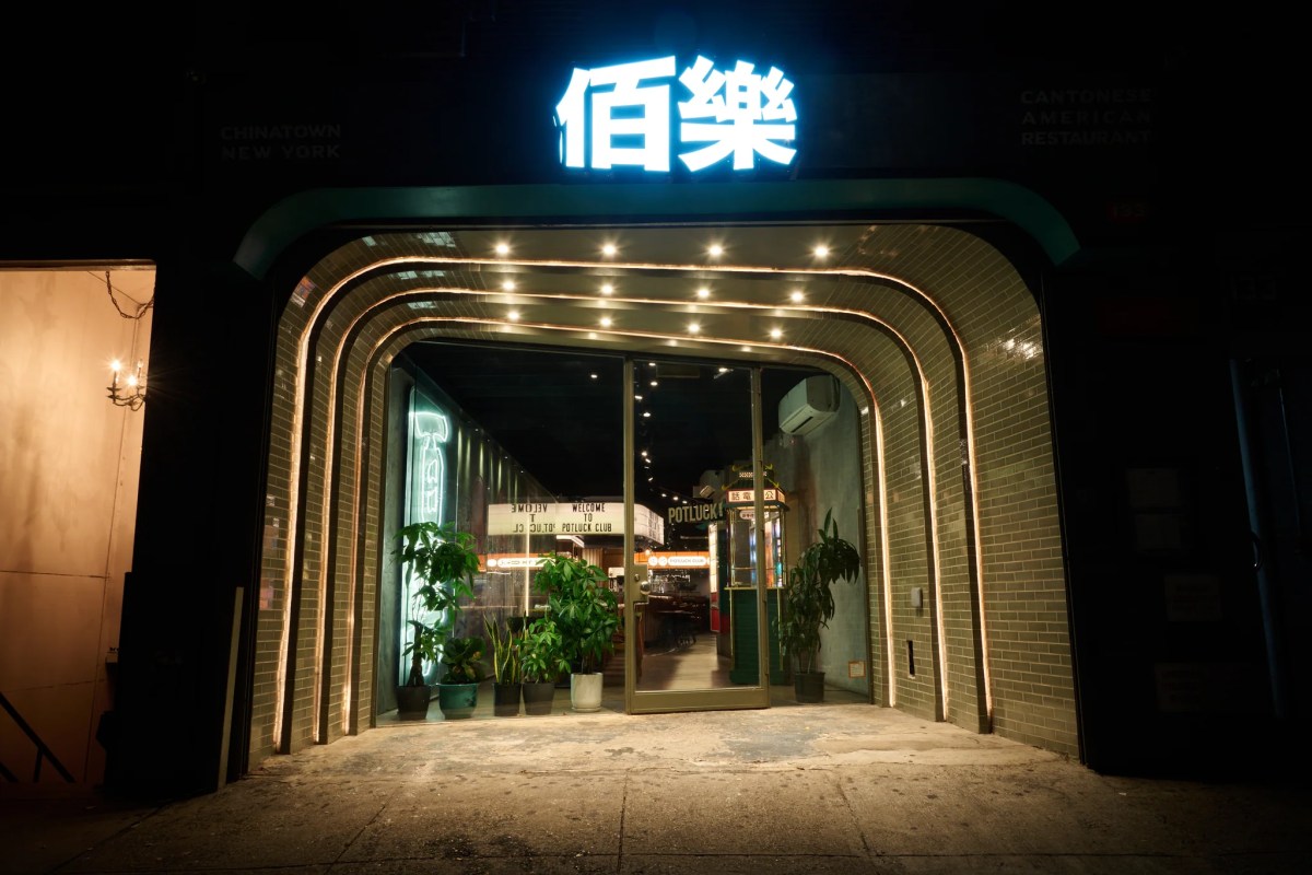 Exterior entrance of Potluck Club at night with glowing neon Chinese sign and tiled archway