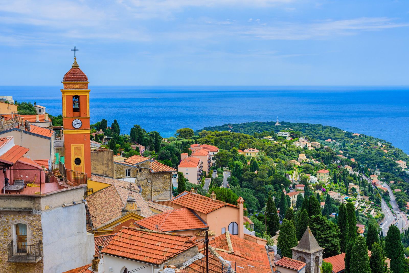 The bell tower and red roofs of Roquebrune's medieval village above the coast