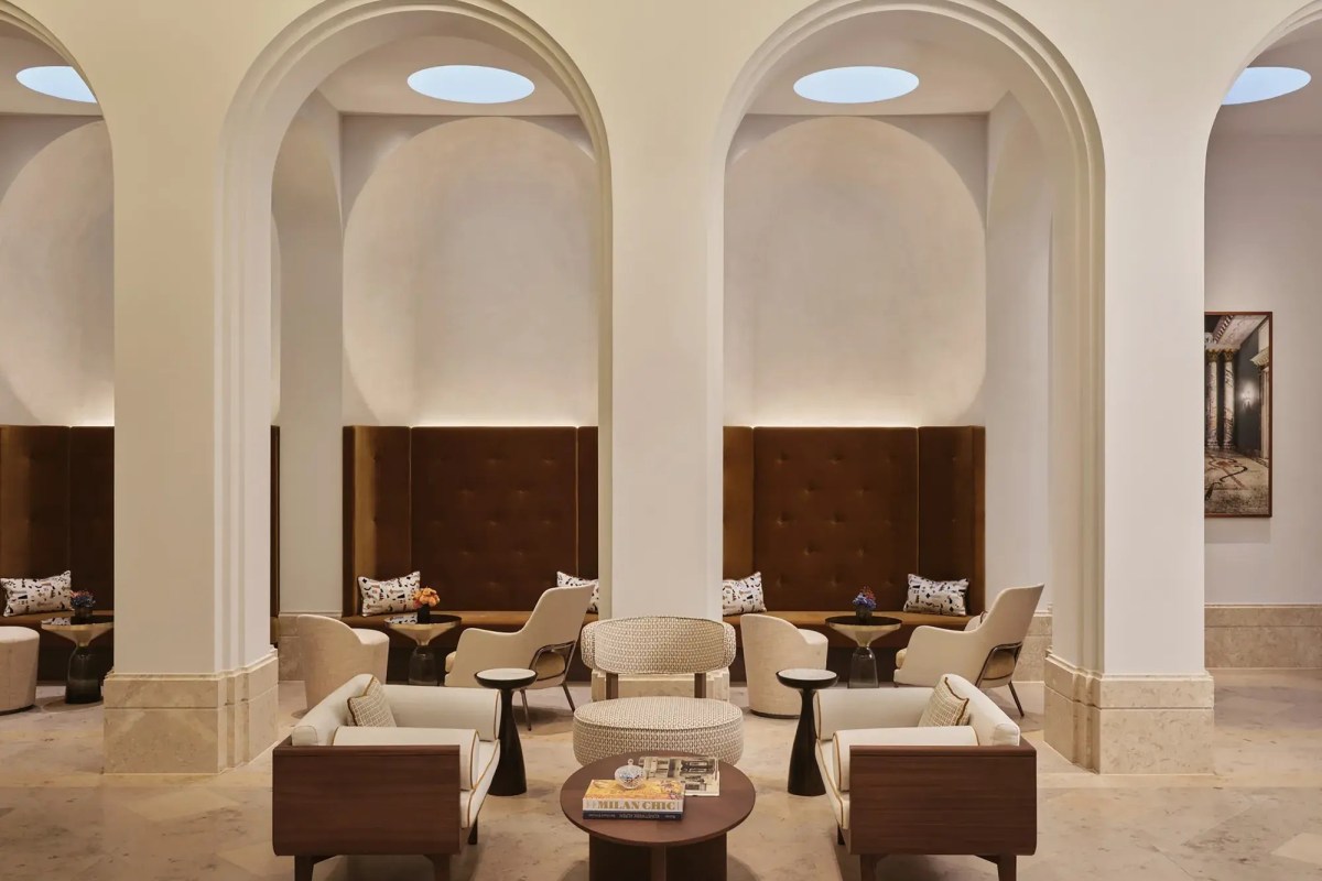 Arched lounge seating area with velvet banquettes and armchairs