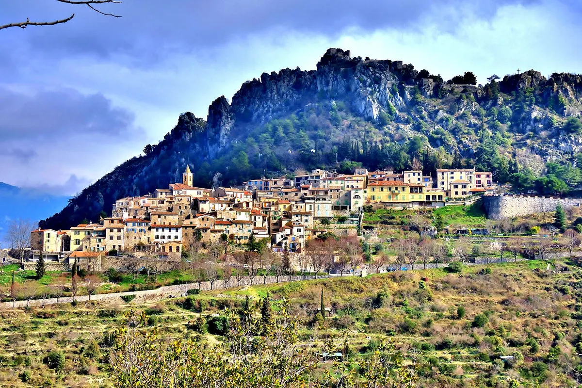 The perched village of Sainte-Agnès strung along a ledge beneath a rocky crest above Menton