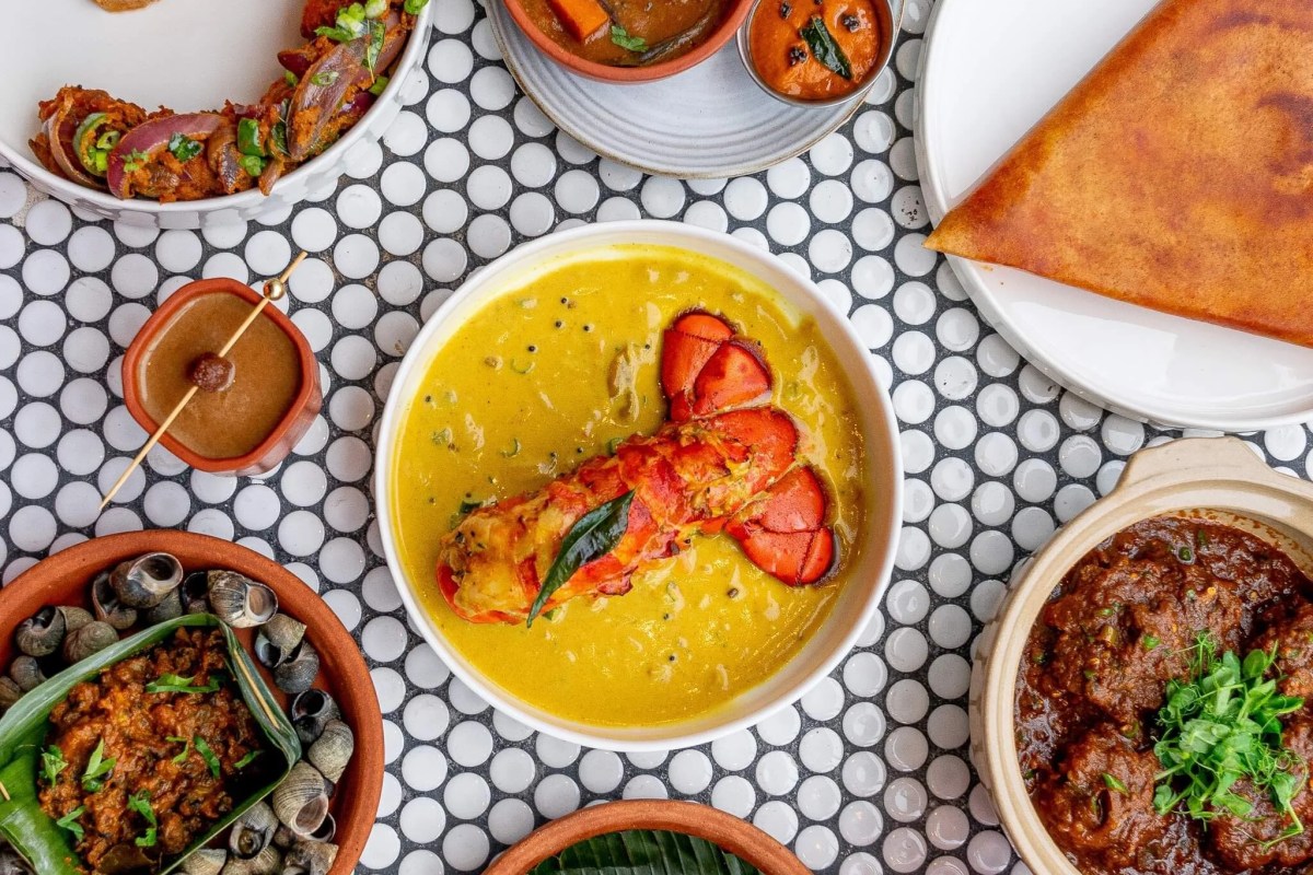 Overhead spread of multiple Semma dishes including lobster curry, dosa, and small plates on a tiled table