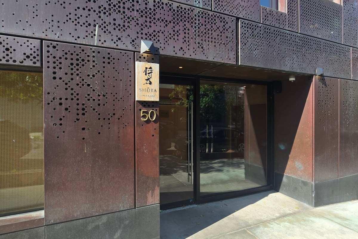 Entrance facade of Shota Omakase with perforated metal panels and glass door, address 50