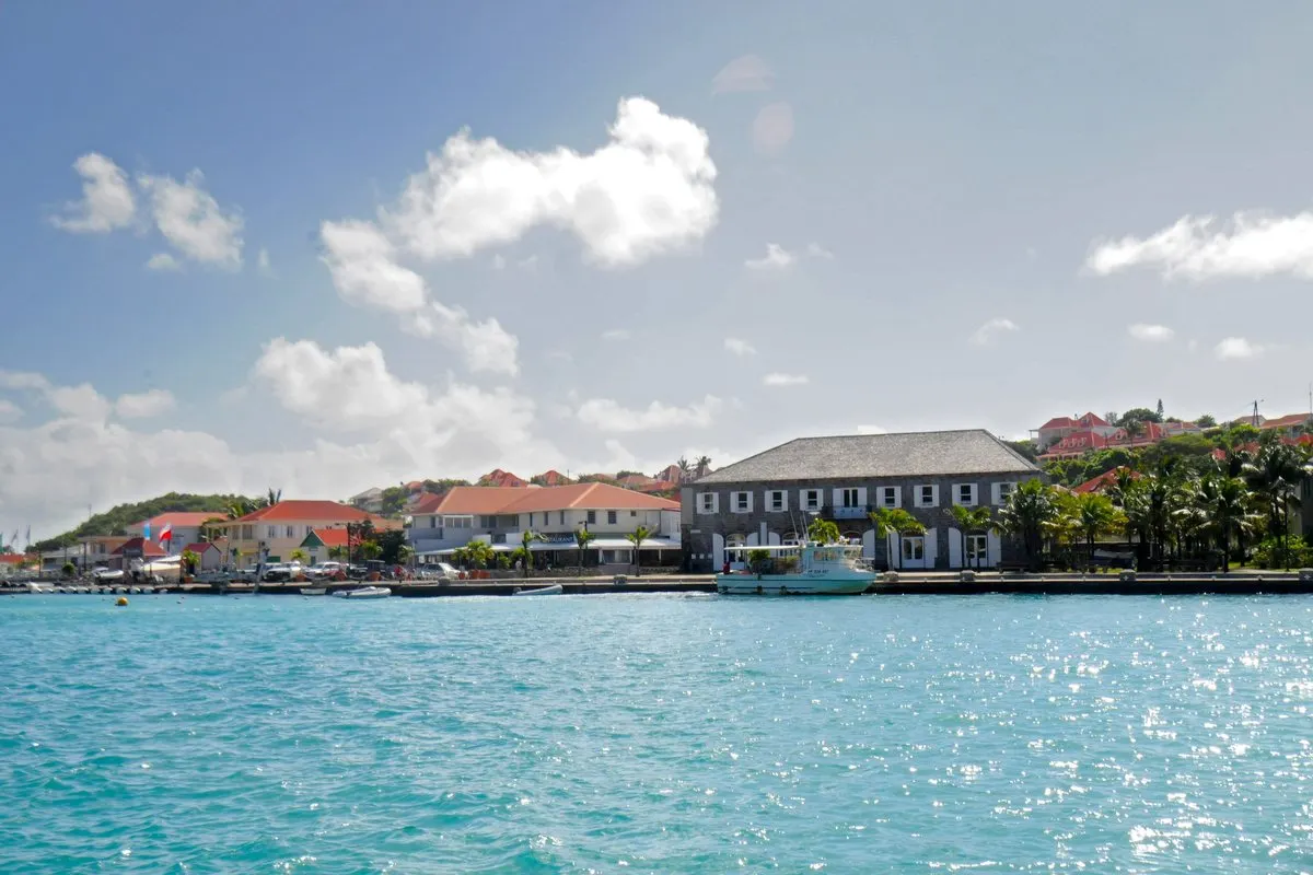 Gustavia harbour on Saint Barthélemy seen from the water, with the town hall and red roofs along the quay