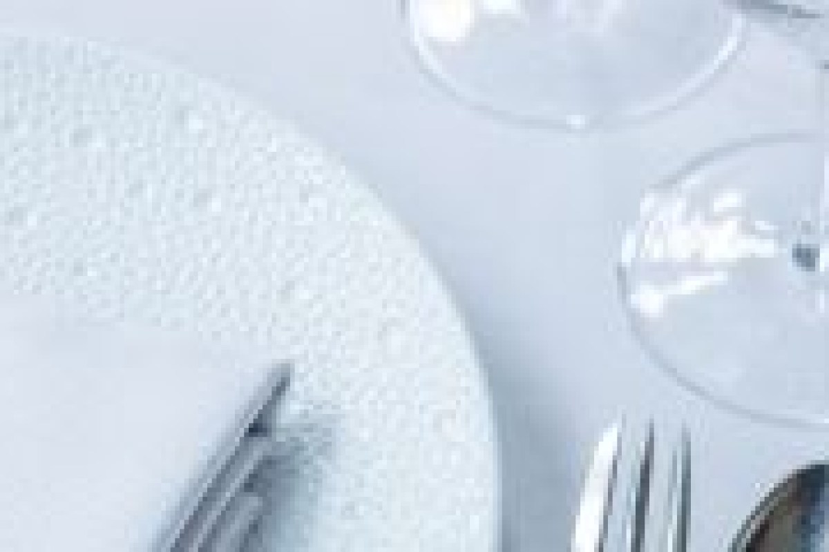 Close-up of table setting with plate, cutlery and glasses