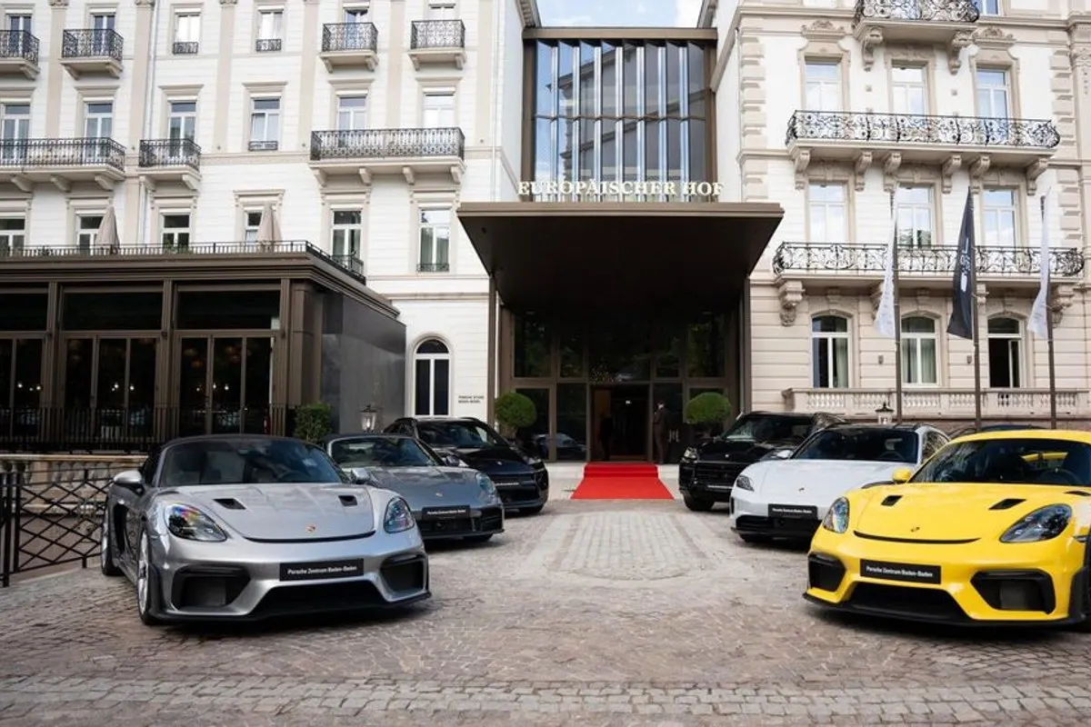 Front façade of the Steigenberger Icon Europäischer Hof hotel with a row of sports cars and red carpet at the entrance