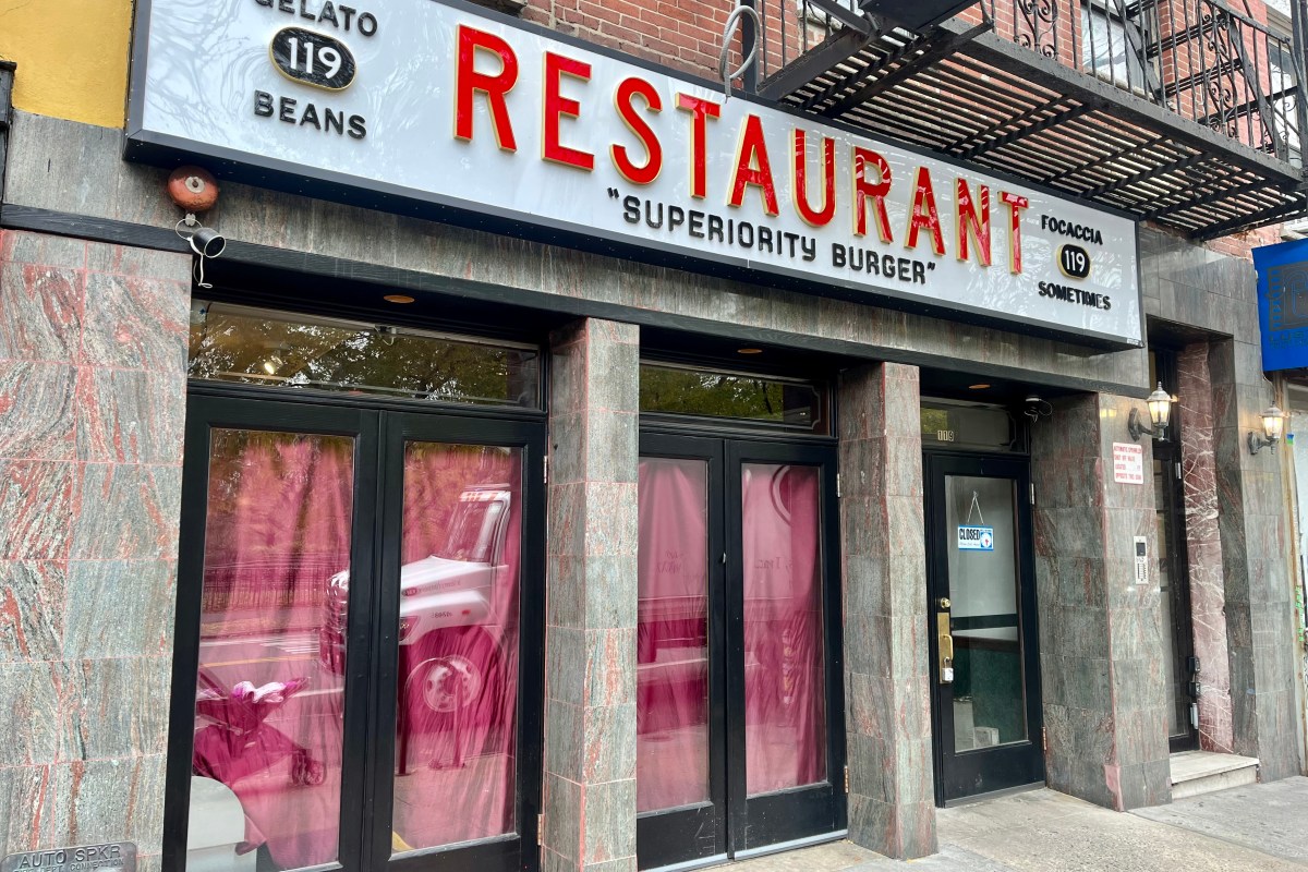 Exterior storefront of Superiority Burger restaurant with large sign reading Restaurant Superiority Burger, closed sign on door