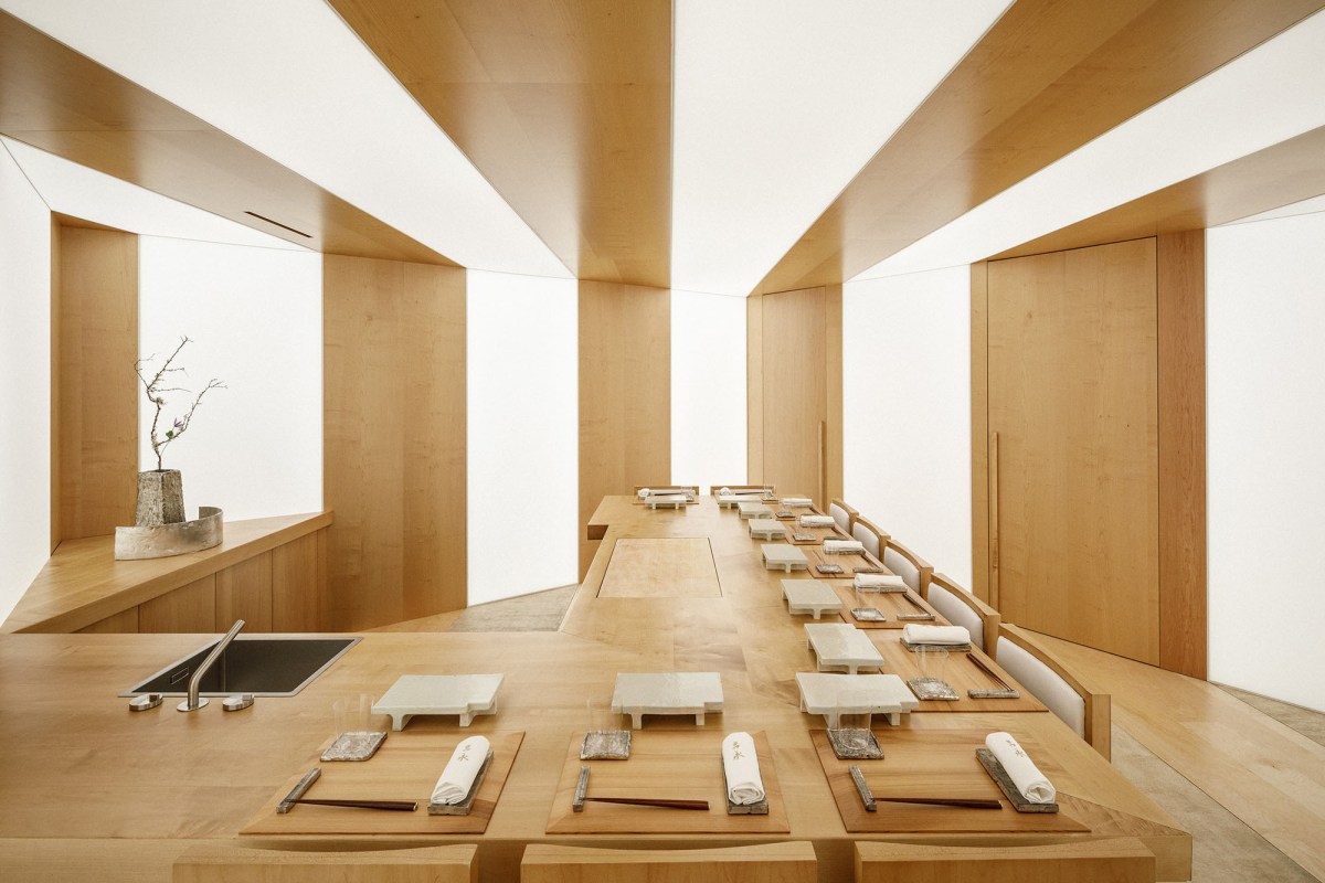 Elegant wood-lined sushi dining room with counter seating and place settings