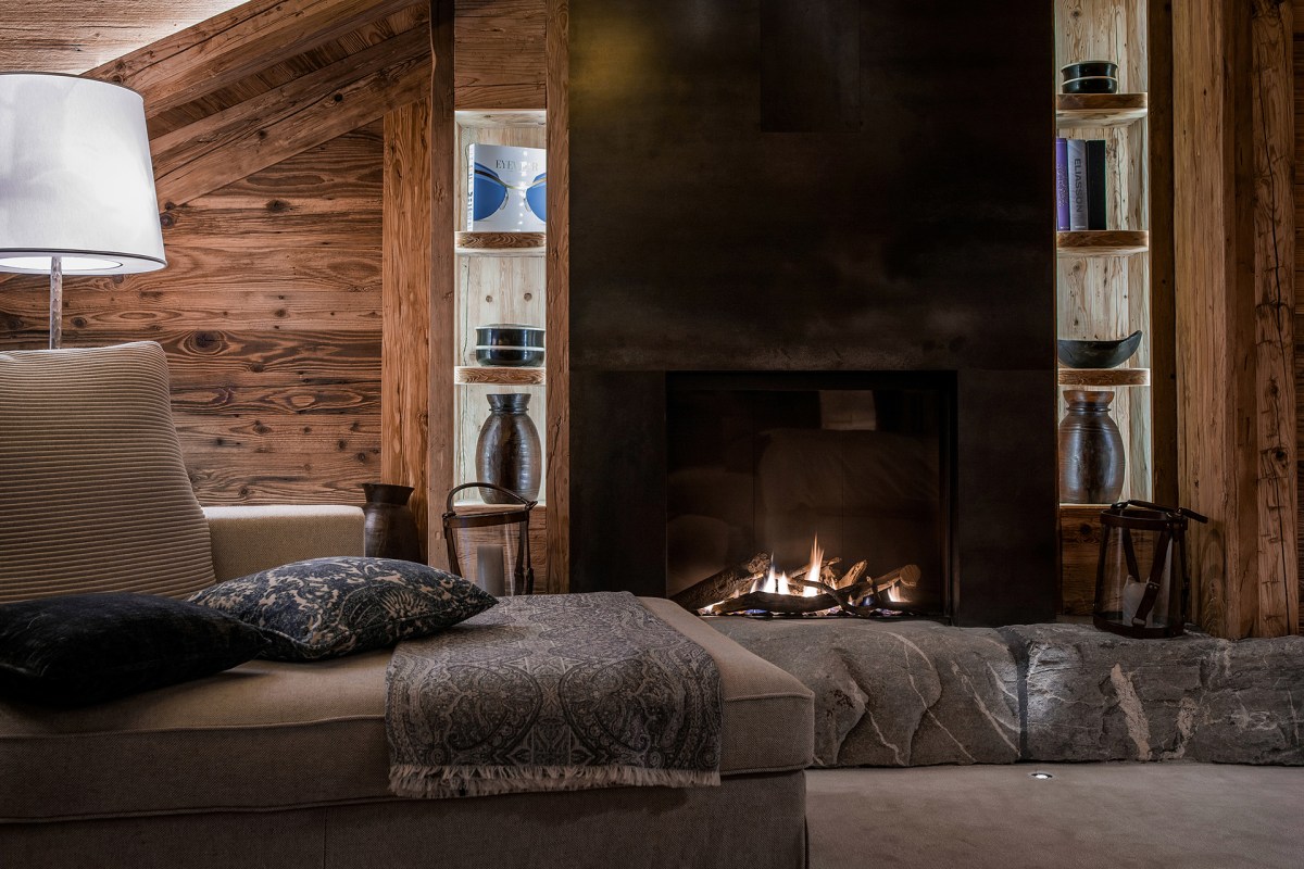 Guest room seating area with fireplace and wooden interior