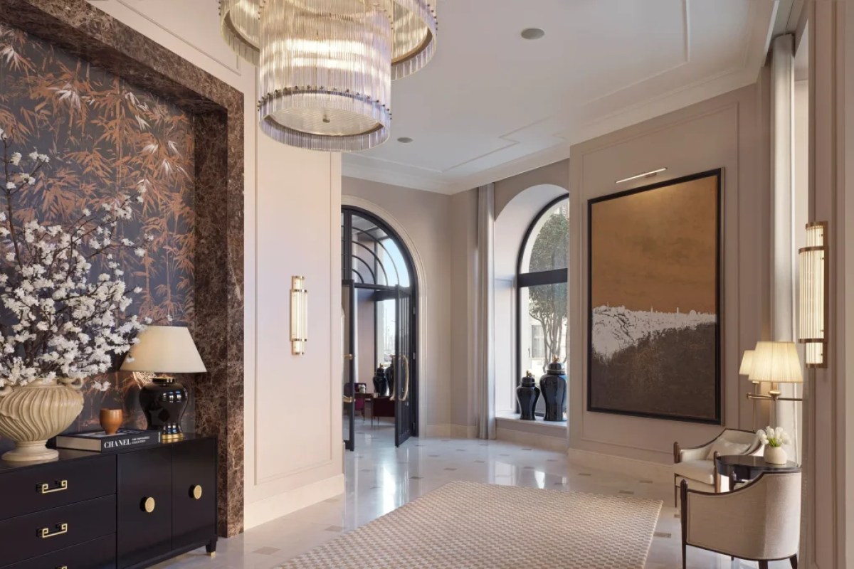 Elegant hotel lobby corridor with marble floors, chandelier, art pieces and seating area