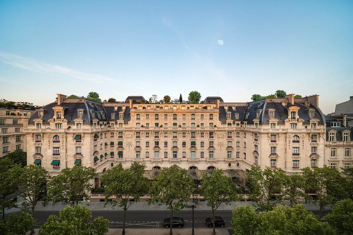 The Belle Époque façade of The Peninsula Paris on avenue Kléber, framed by plane trees