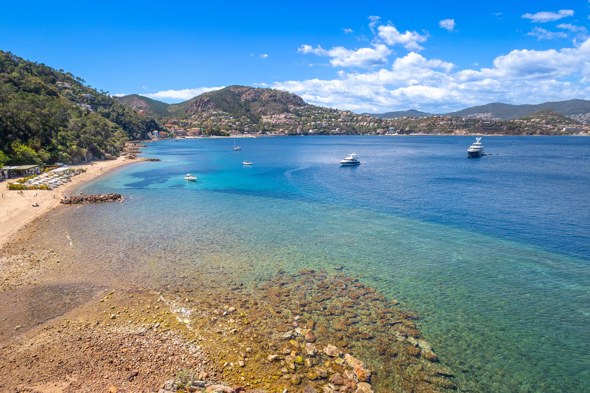 A beach at Théoule-sur-Mer below the red cliffs of the Esterel