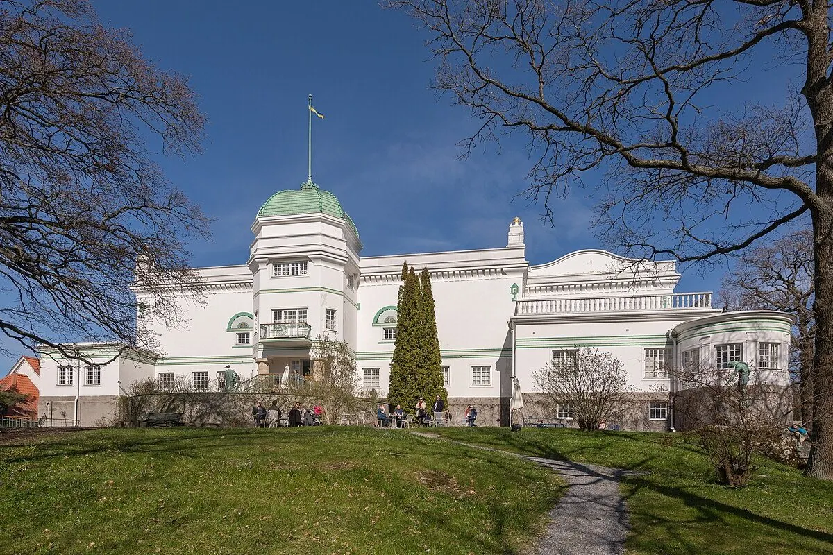 The white Jugendstil villa of the Thiel Gallery with its green dome on Blockhusudden, Djurgården, Stockholm, on a spring day