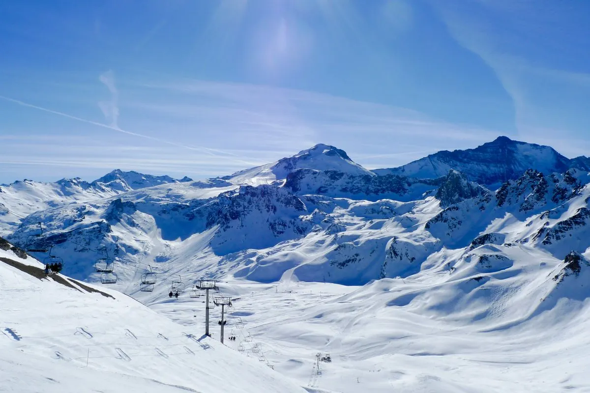 A ski lift and snow-covered peaks in Tignes on a sunny winter day
