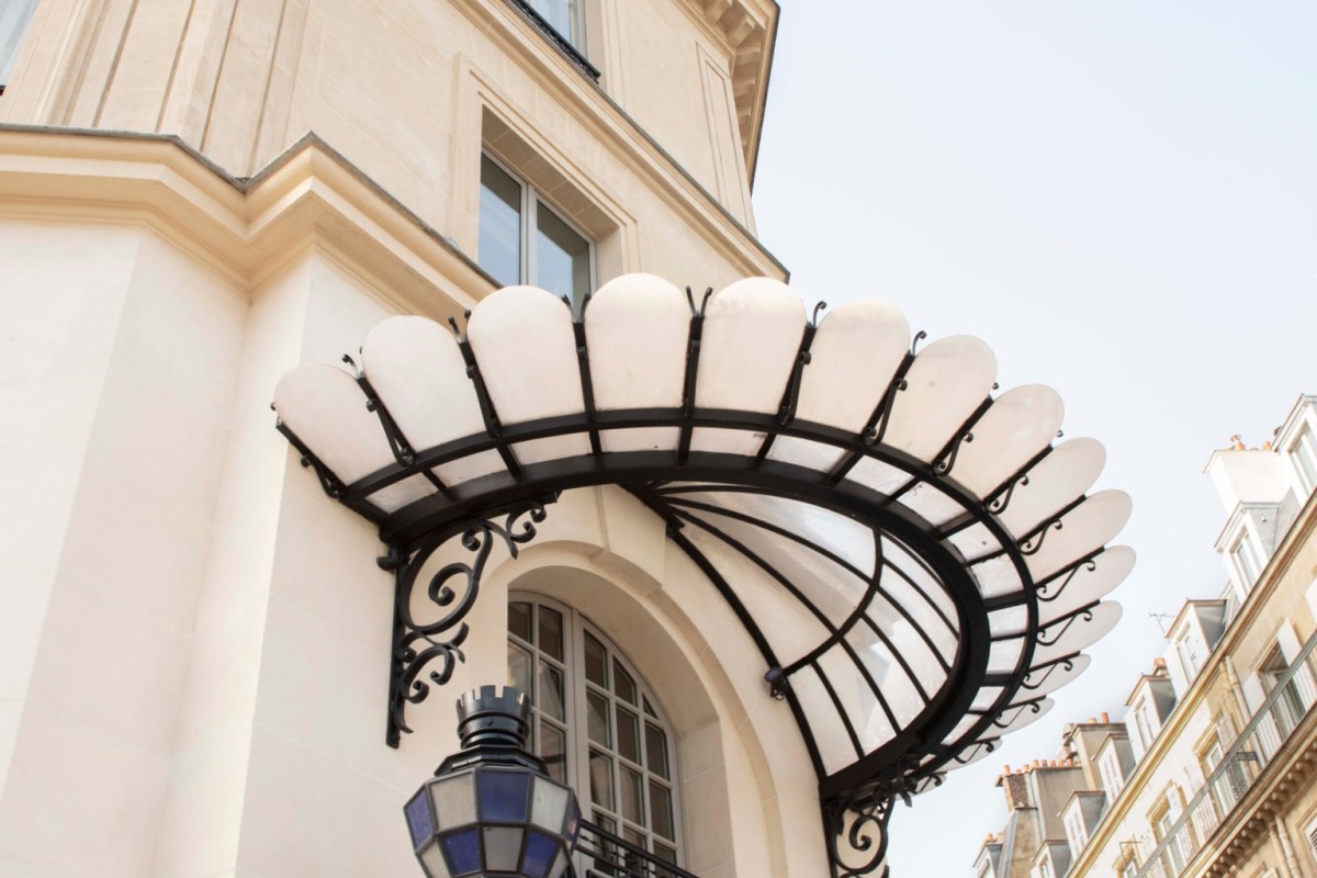 Ornate Belle Époque glass and iron canopy over the restaurant's Paris entrance