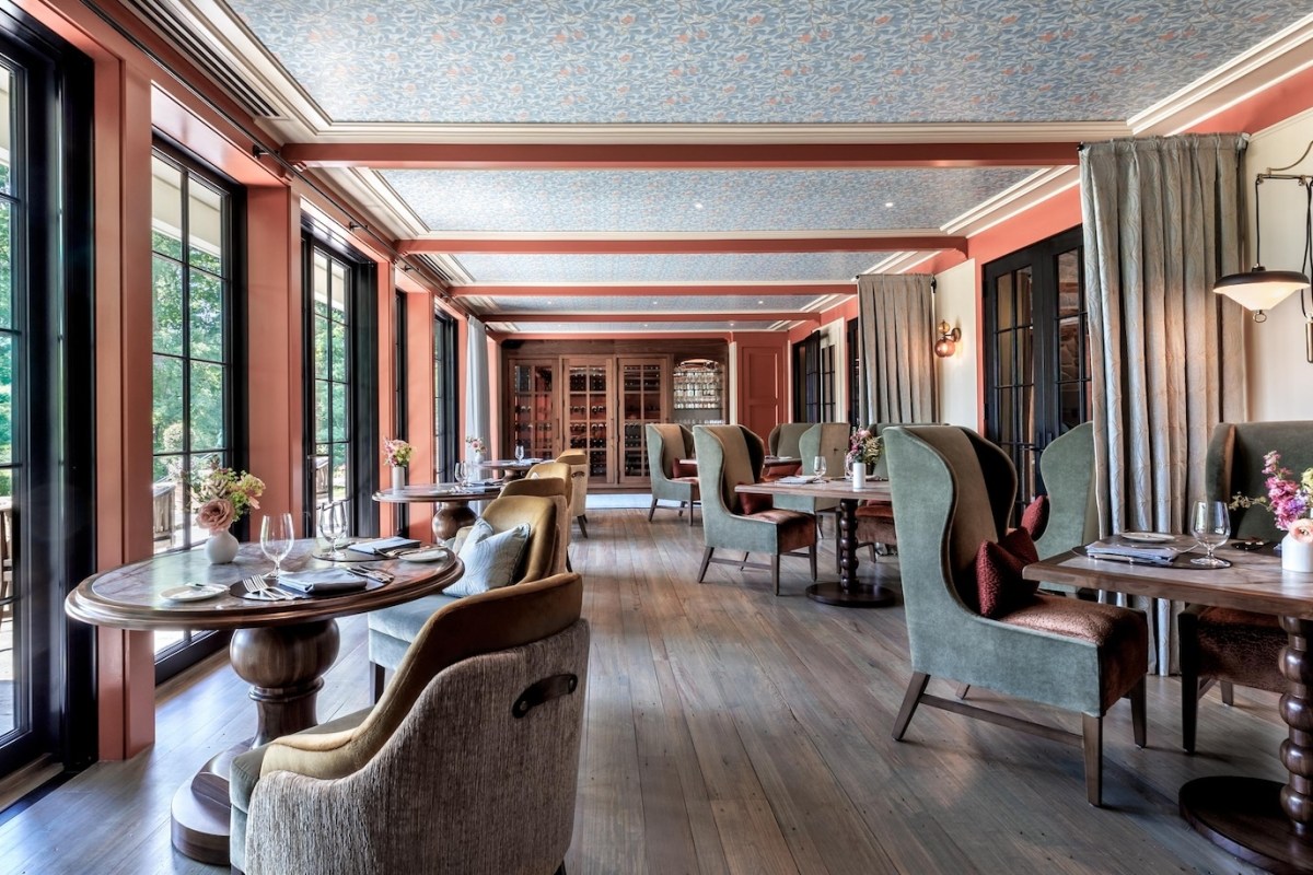 Elegant dining room interior at Twin Farms with patterned ceiling and upholstered chairs