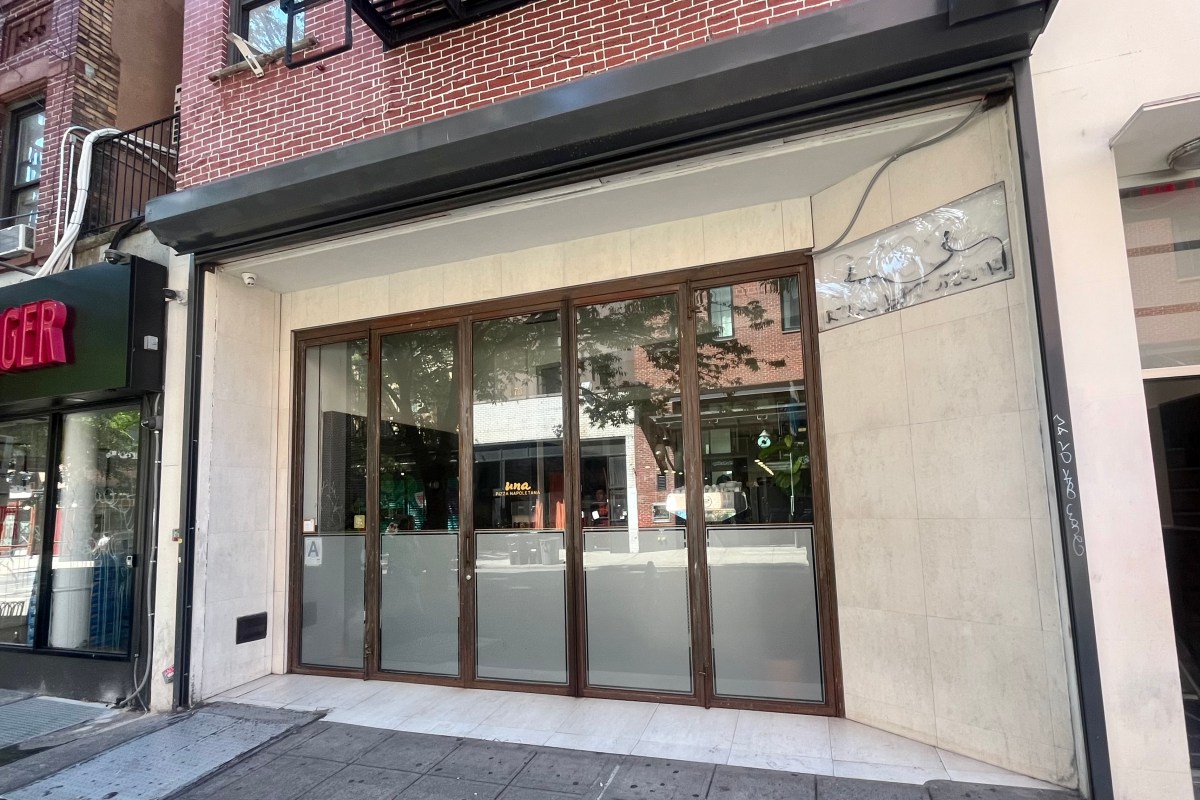 Exterior storefront of Una Pizza Napoletana with folding glass doors on a New York street.