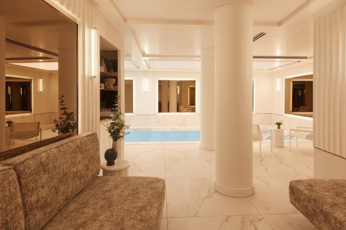 Elegant indoor pool area with marble columns and lounge seating