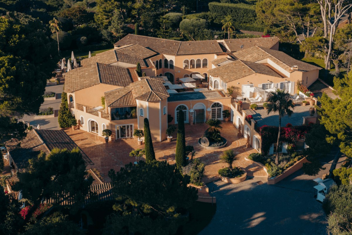 Aerial view of the villa-style hotel complex with terracotta roofs, courtyards and pool