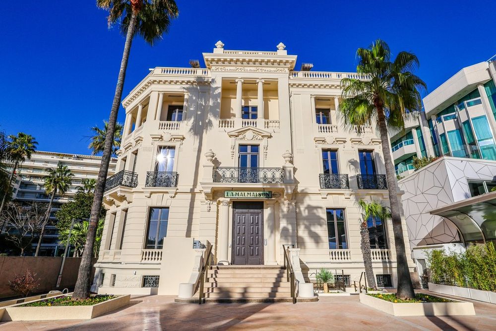The Belle Époque façade of La Malmaison art centre on the Croisette, framed by palms