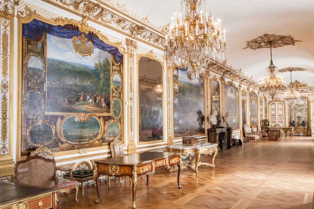 Chandeliers and battle paintings in the Galerie des Batailles at the Château de Chantilly