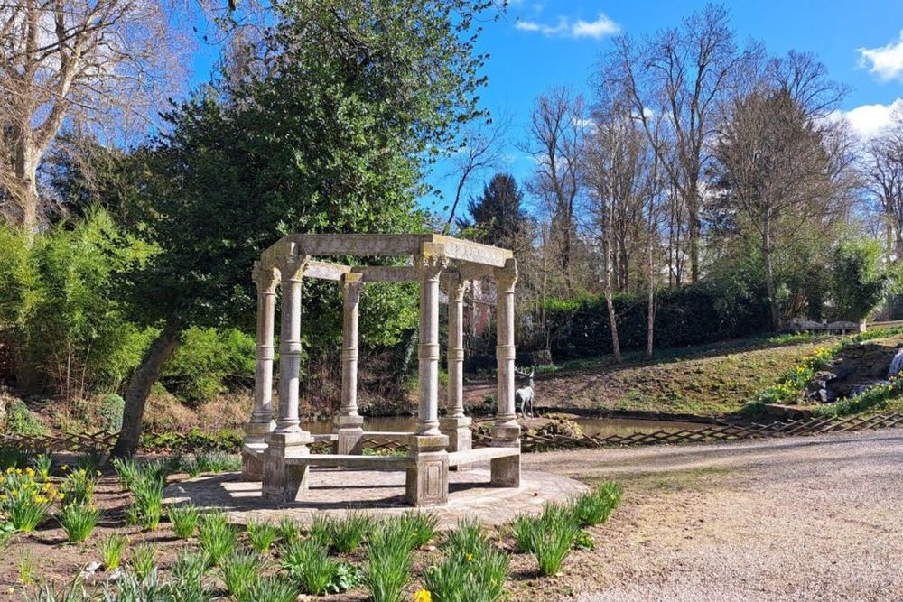A stone gazebo among the beds and bamboo of the Potager des Princes