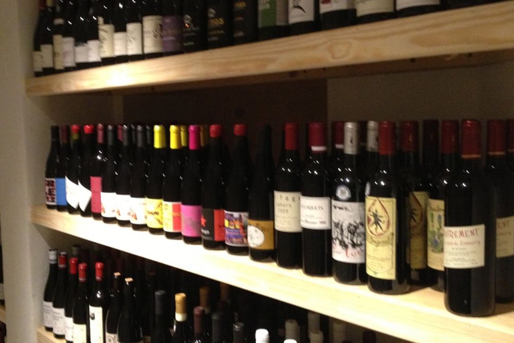 Shelves stacked with bottles of natural wine at Den Vandrette on Havnegade