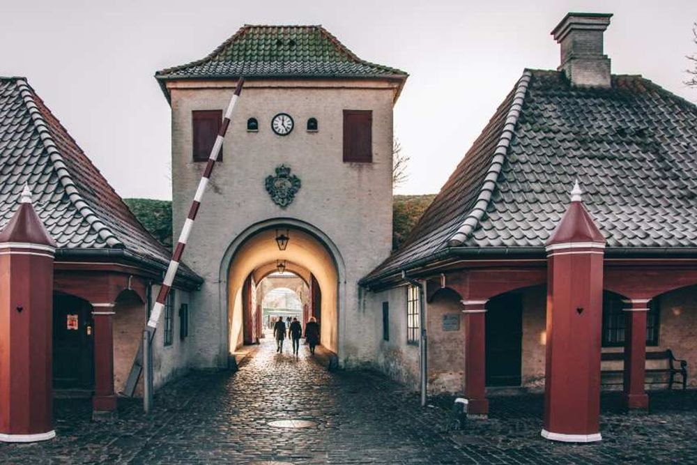 The red-and-white gatehouse and cobbled passage leading into Kastellet, the Citadel
