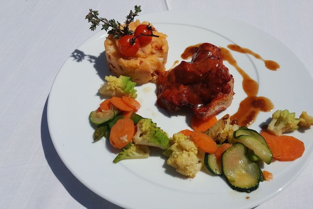 A plated main course with a vegetable medley and tomato tartare at Le Pescadou, Gassin