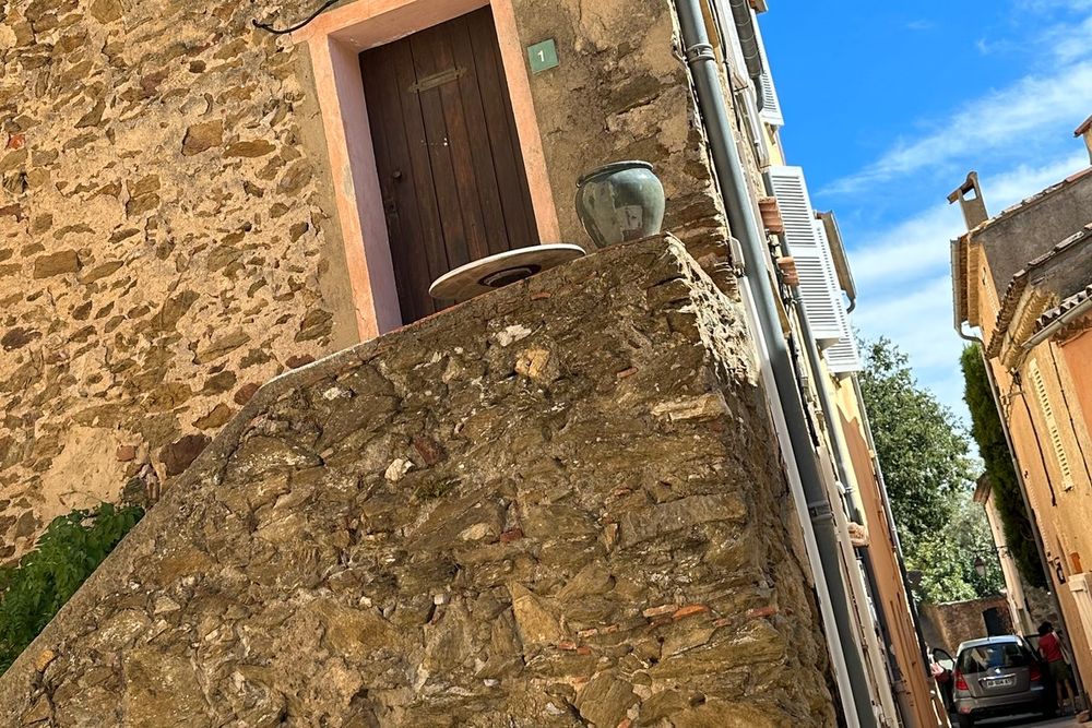 A stone stairway leading up to an old doorway in the medieval village of Gassin