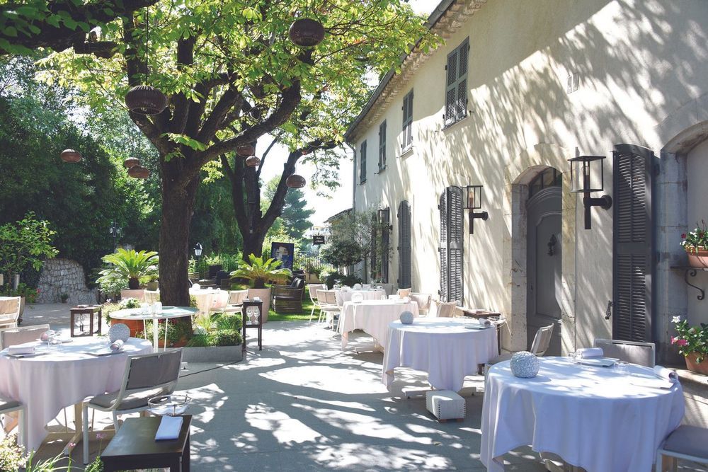 White-clothed tables on the shaded terrace of La Villa Archange, an 18th-century bastide in Le Cannet
